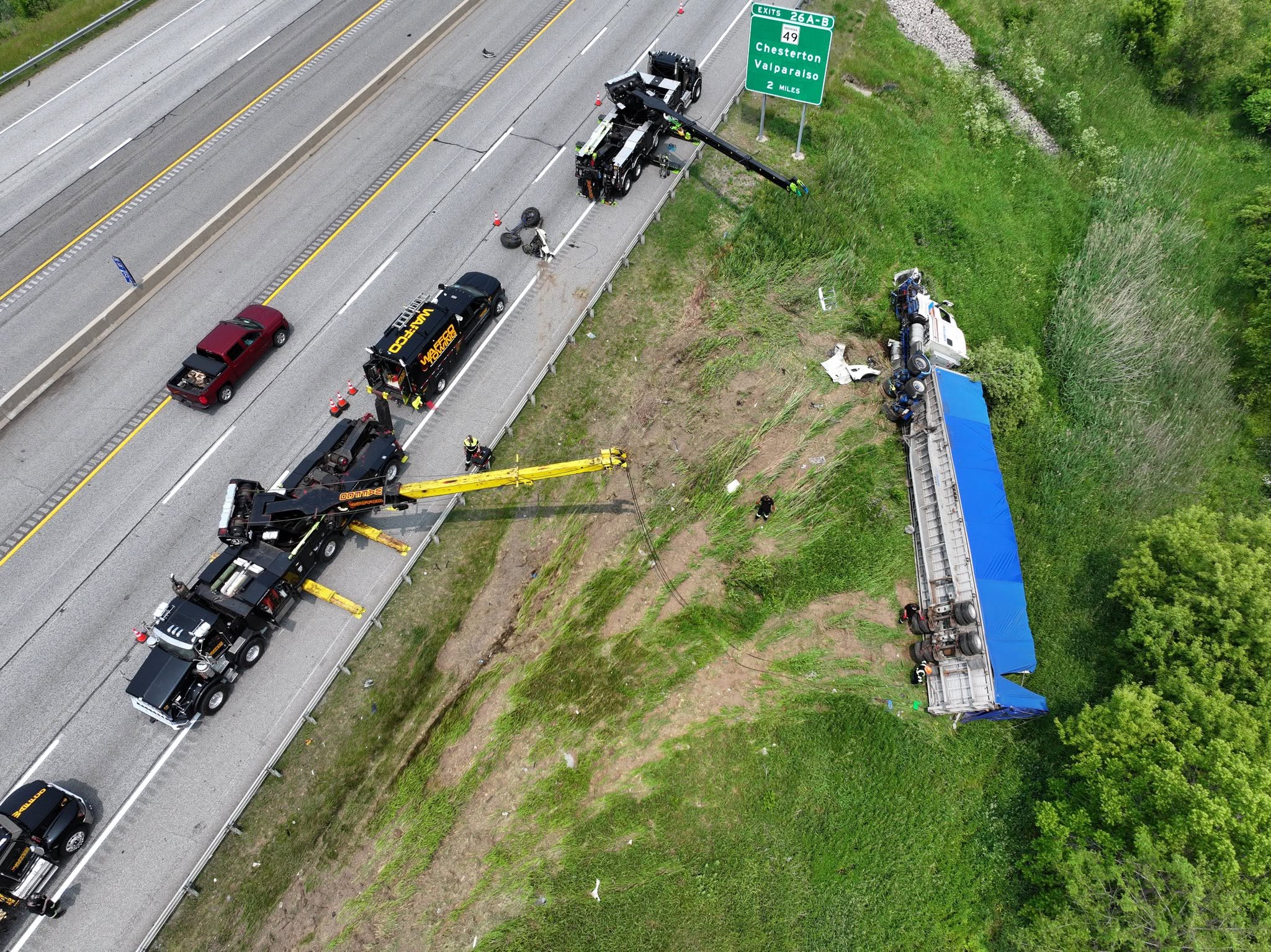 Rotators recovering an overturned tractor trailer from a highway shoulder